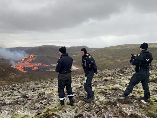 Icelandic Coast Guard staff viewing the eruption earlier today.